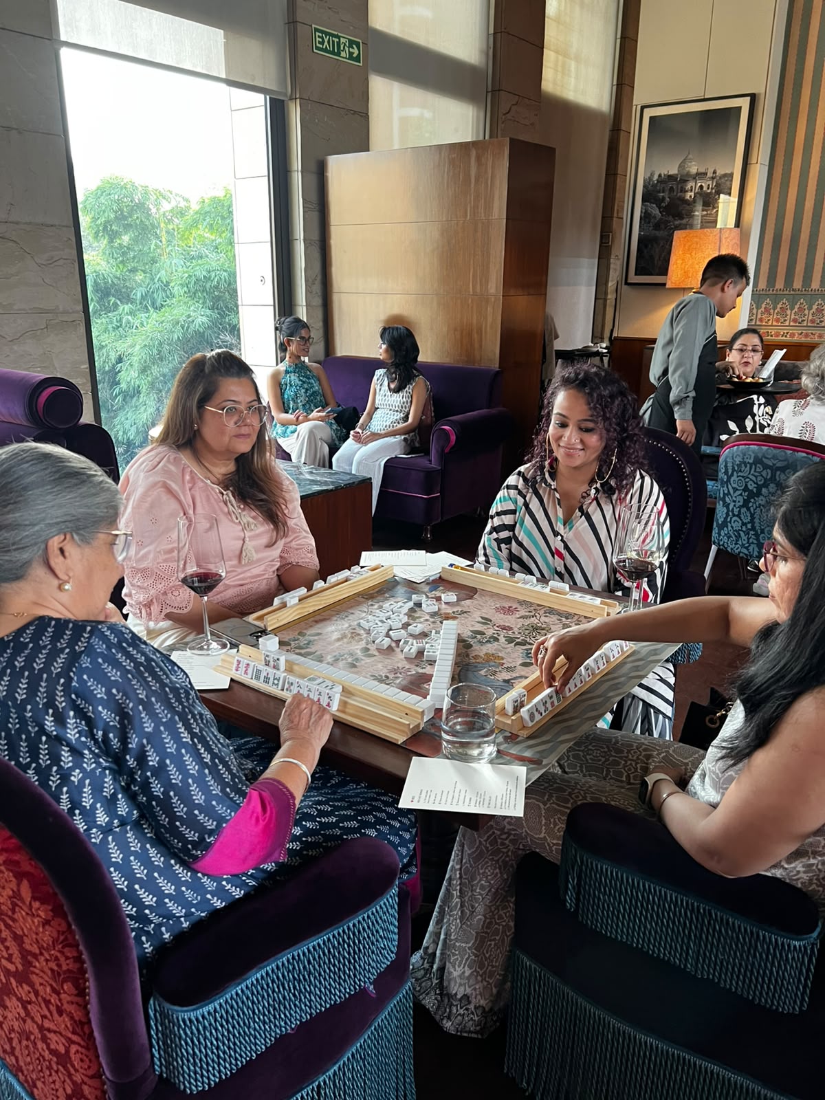 People playing Mahjong at a table